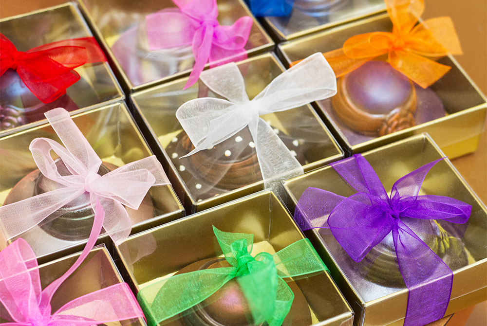 chocolate bonnets on store shelf boxed with a variety of colored bows view image